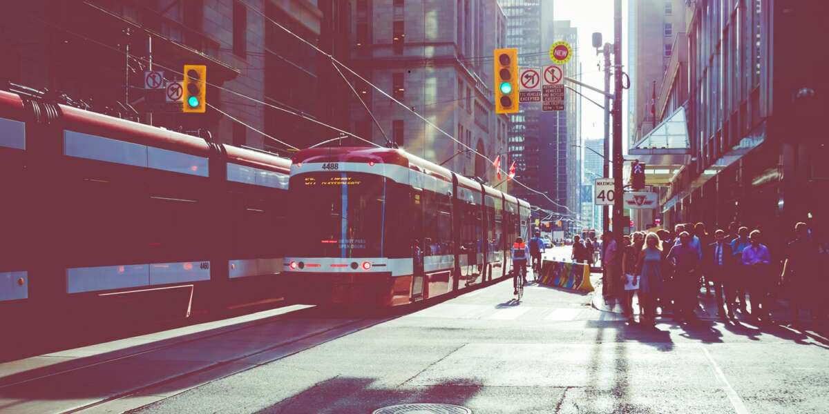 TORONTO, CANADA - SEPTEMBER 17, 2018: Rush hour at Toronto's busiest intersections. Financial district at the background.