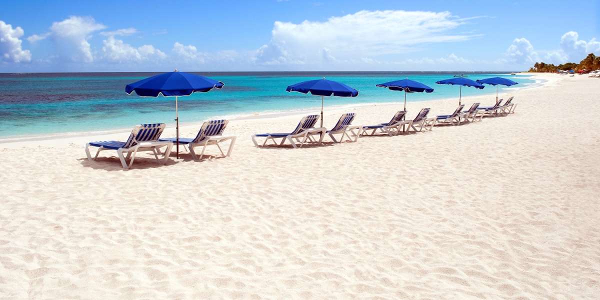 Sunbeds and beach umbrellas at beautiful caribbean beach.
