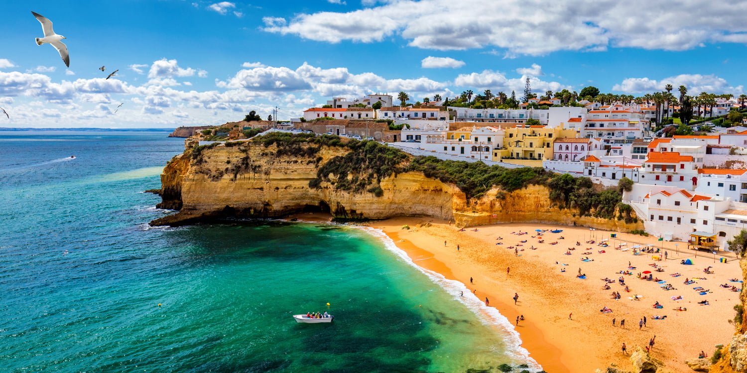 View of Carvoeiro fishing village with beautiful beach, Algarve, Portugal. View of beach in Carvoeiro town with colorful houses on coast of Portugal. The village Carvoeiro in the Algarve Portugal.