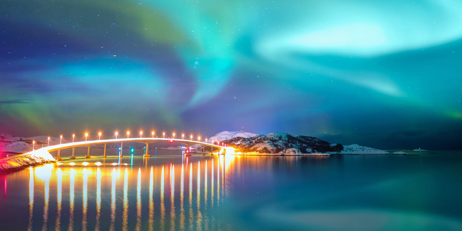 Sommaroy Bridge is a cantilever bridge connecting the islands of Kvaloya and Sommaroy with Aurora Borealis - Hillesoy Tromso Norway