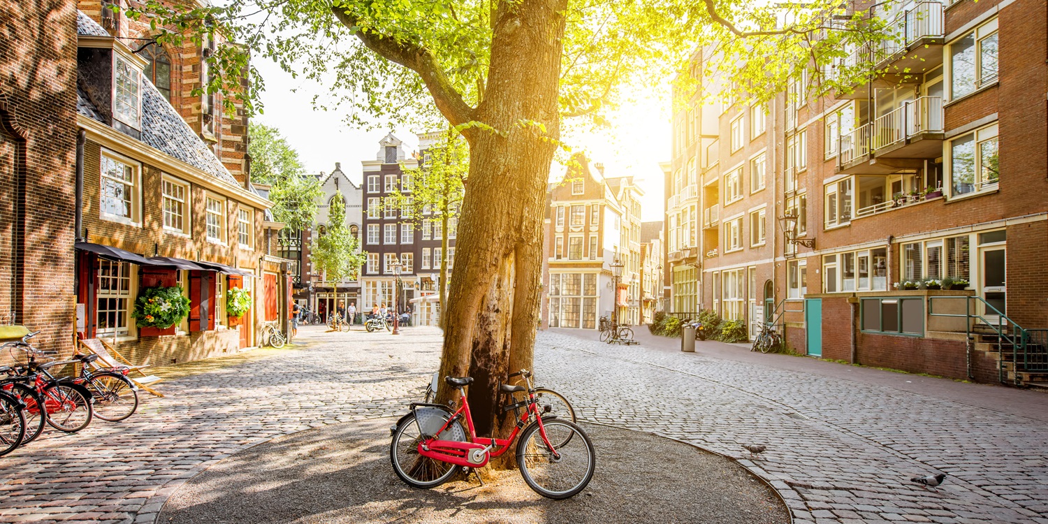 Morning view on the square with beautiful buildings near the Old Church in Amsterdam city