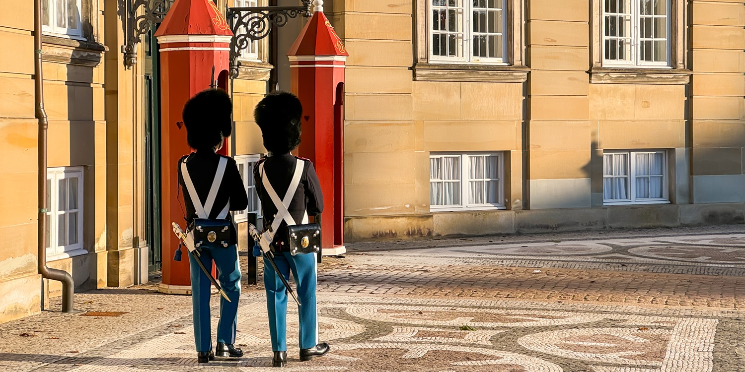 Traditional Danish ceremonial guards, soldier, in palace Amalienborg in capital Copenhagen, with bright red guard house