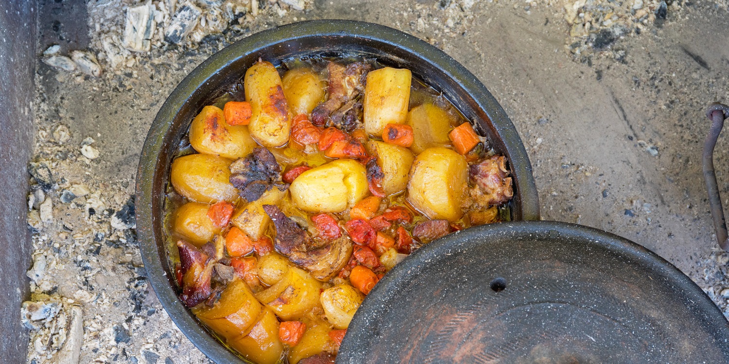 Dutch Cuisine - Slow Cooking in Dutch Oven at Coals Fire