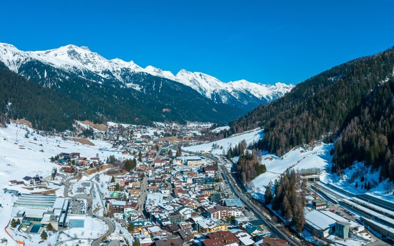 St Anton Ski resort town of St. Anton am Arlberg in Austria with amazing winter sunny sky and snowy mountains covered with pine trees in the background