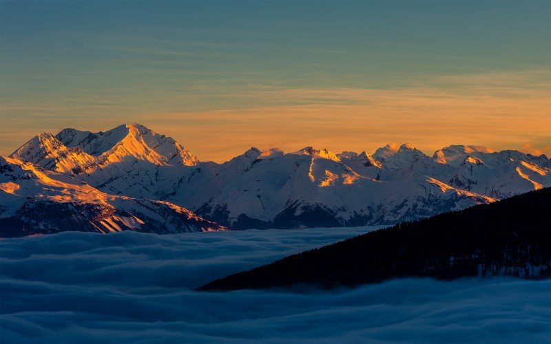 Scenic panorama sunset landscape of Crans-Montana range in Swiss Alps mountains with peak in background, Crans-Montana, Switzerland. 